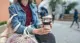 Women holding reusable coffee mug
