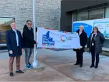 Simon Gill, Director of Economic Development and Tourism; Sterling Lee, Regional Councillor; John Henry, Regional Chair and CEO; and Teresa Shaver from Business Advisory Centre Durham holding the Do It In Durham Flag