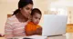 Mom-sitting-at-table-with-baby-boy-looking-at-laptop.jpg