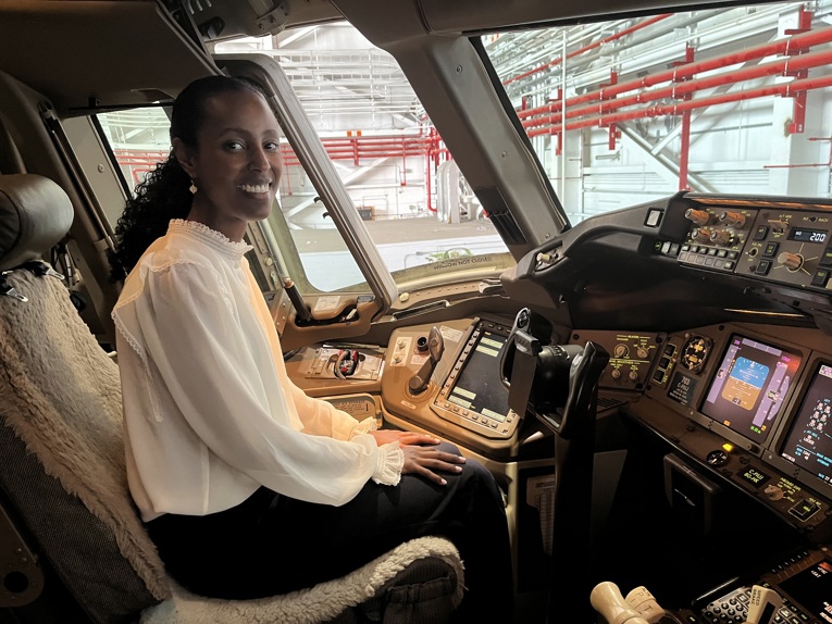 Dr. Wintta Ghebreiyesus sitting in one of her autonomous vehicles.Dr. Wintta Ghebreiyesus in the cockpit of an aircraft at the Elevate Cross Country Tour.