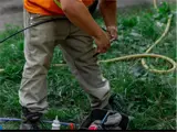 A person cutting cables and wires.
