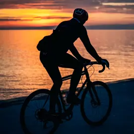Photo by James Meloche of a person cycling along Lake Ontario waterfront at sunset in Durham Region, Ontario 