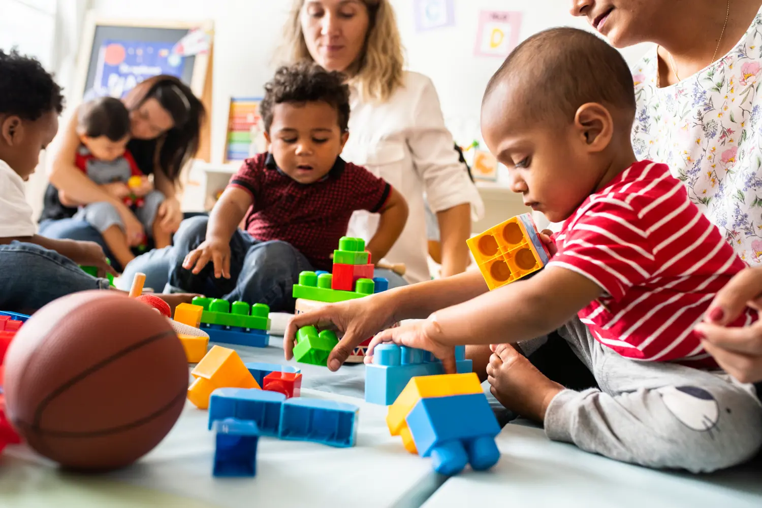 Diverse-group-of-parents-and-children-playing-together-with-blocks.jpg