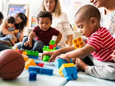 Diverse-group-of-parents-and-children-playing-together-with-blocks.jpg