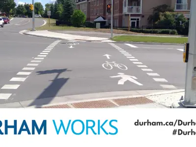 Image shows a mixed crossride. An icon of a person walking and a bike are also painted on the road. Text under image states: “Durham Works, durham.ca/DurhamWorks #DurhamWorks.”