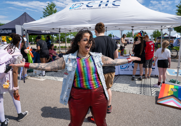 A person showing off their pride in colourful clothes.