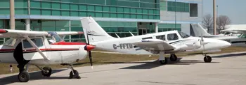 Three planes on tarmac at Oshawa Executive Airport, including Cessna and C-FFYD