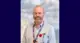 A head shot of Allan with a blurred background.