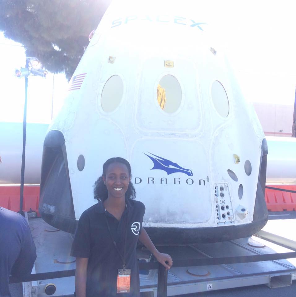 Wintta standing in front of the SpaceX Dragon.