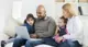 Parents with two children looking at laptop