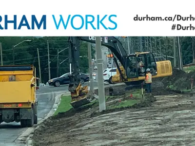 Image of a road construction project. Text over image states: “Durham Works, durham.ca/DurhamWorks #DurhamWorks.”