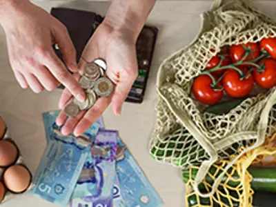 Counting money with food on the table