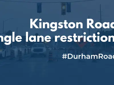 Image of a road under construction at night with traffic cones and barriers. Text overlays the image: 'Kingston Road single lane restrictions #DurhamRoads.'